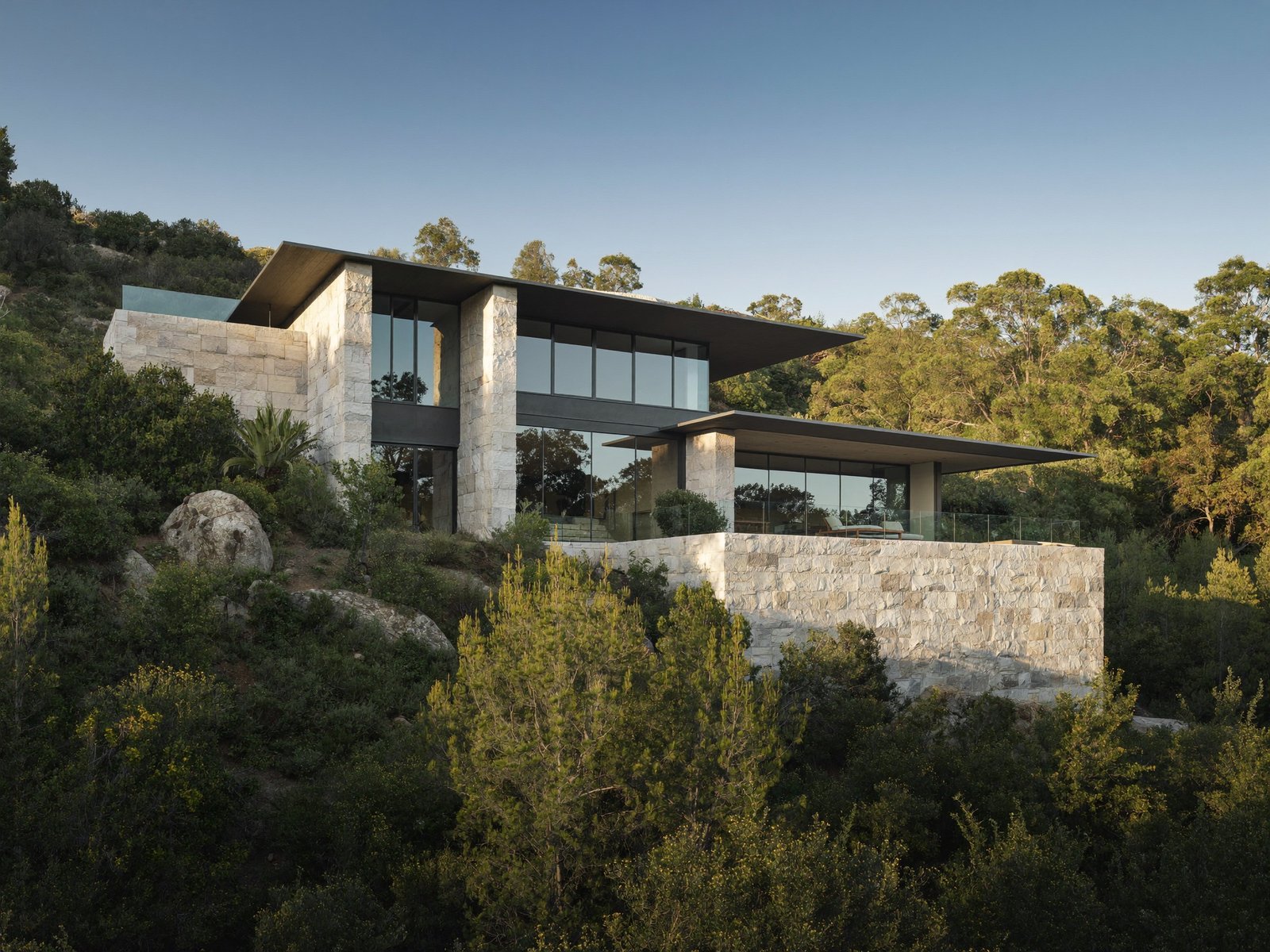 Modern limestone and glass custom residence overlooking Barton Creek in Austin