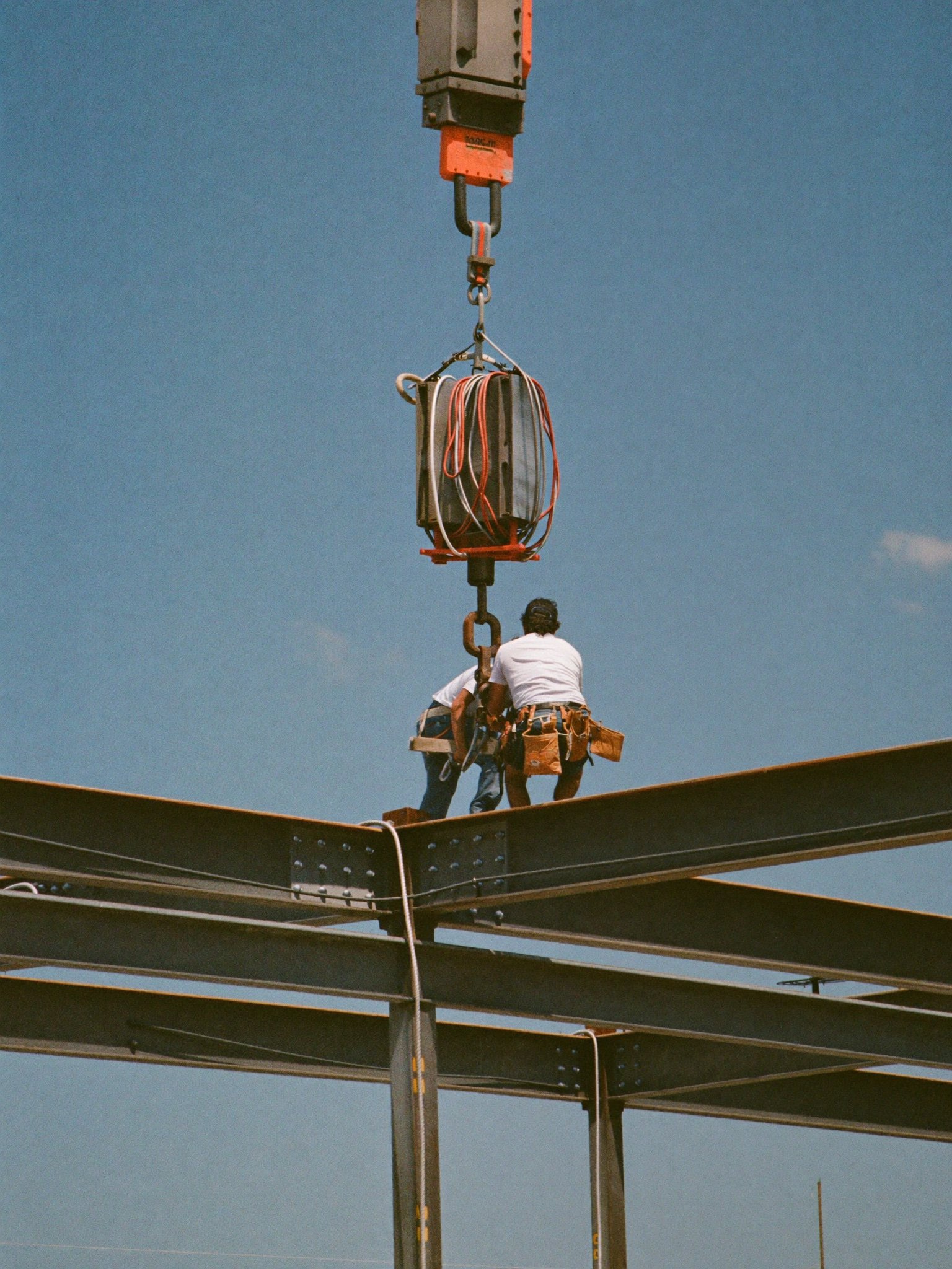 Ironworkers setting structural steel on a commercial building frame in Dallas–Fort Worth